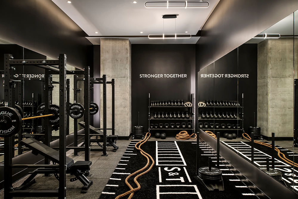 Personal training studio with squat racks, dumbbells, turf, battle ropes, sled push and other equipment at Sweat and Tonic